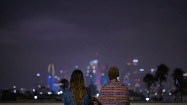 Kate and Helena look at the LA skyline at night