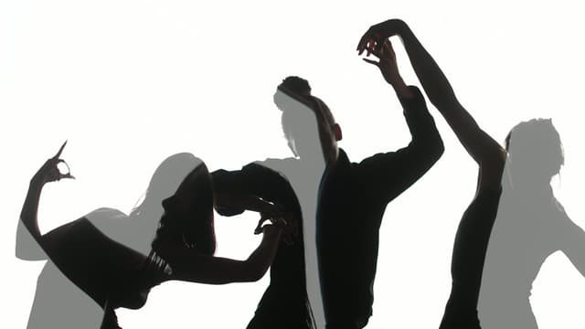 Overlaid images of silhoutted dancers in front of a plain white backdrop