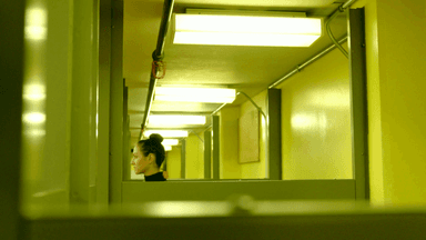 Looking down a row of cubicles as Jone's head appears above one of them