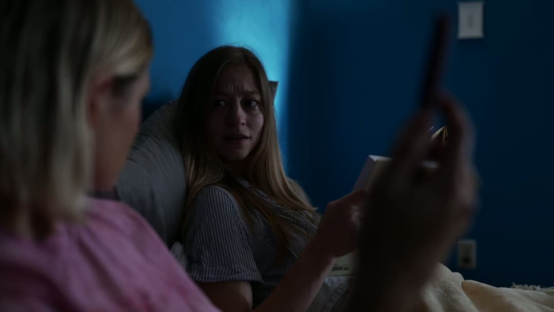 Two women talking in bed